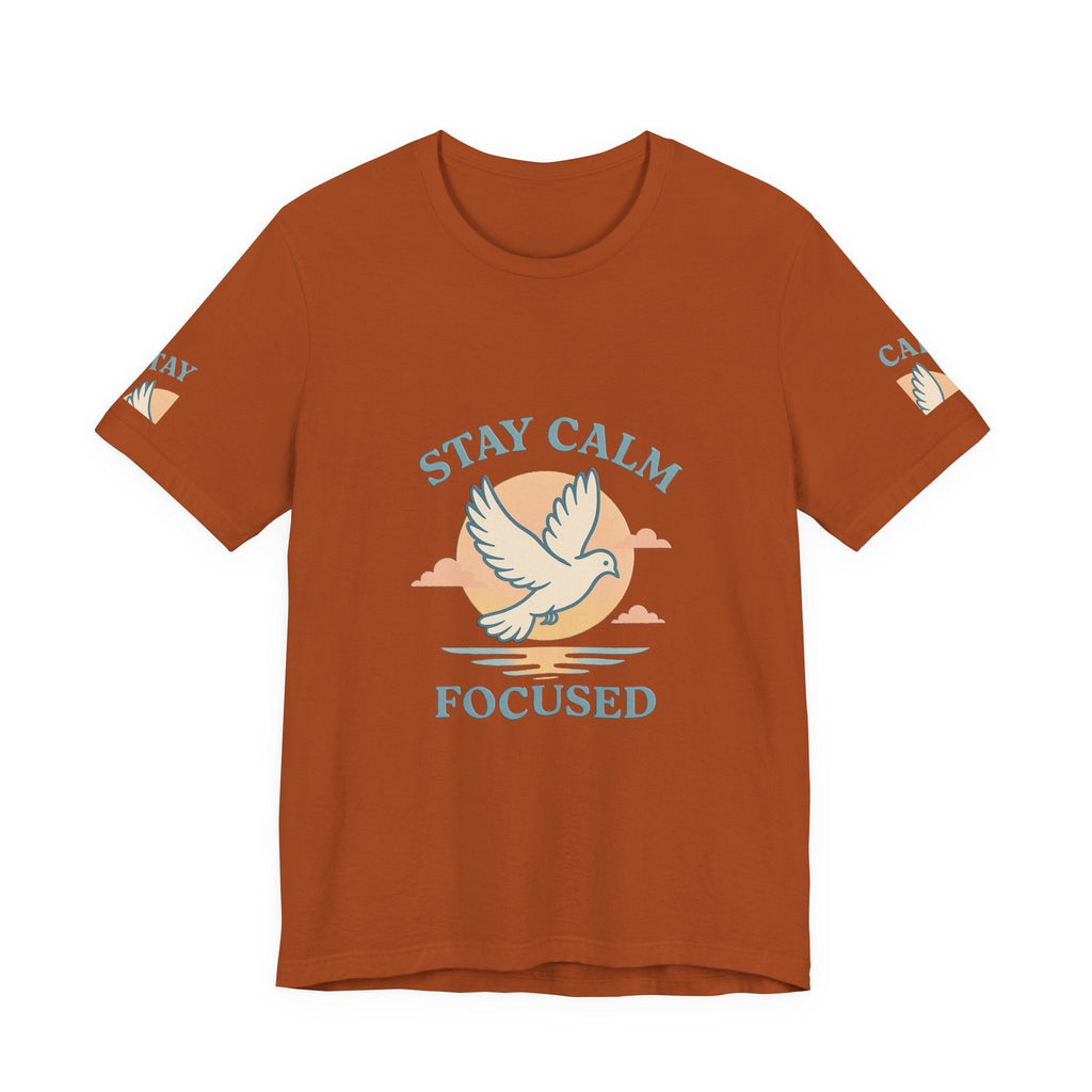 Rust-colored unisex T-shirt with "Stay Calm Focused" text and white dove graphic for motivational everyday wear