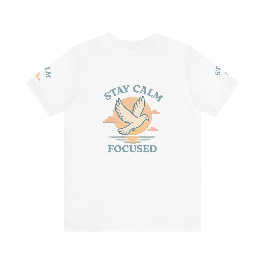 White unisex t-shirt with "Stay Calm Focused" text and dove graphic against a sunset background.