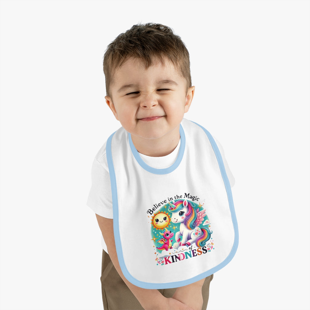Baby Contrast Trim Jersey Bib with "Believe in the Magic of Kindness" design on happy child.