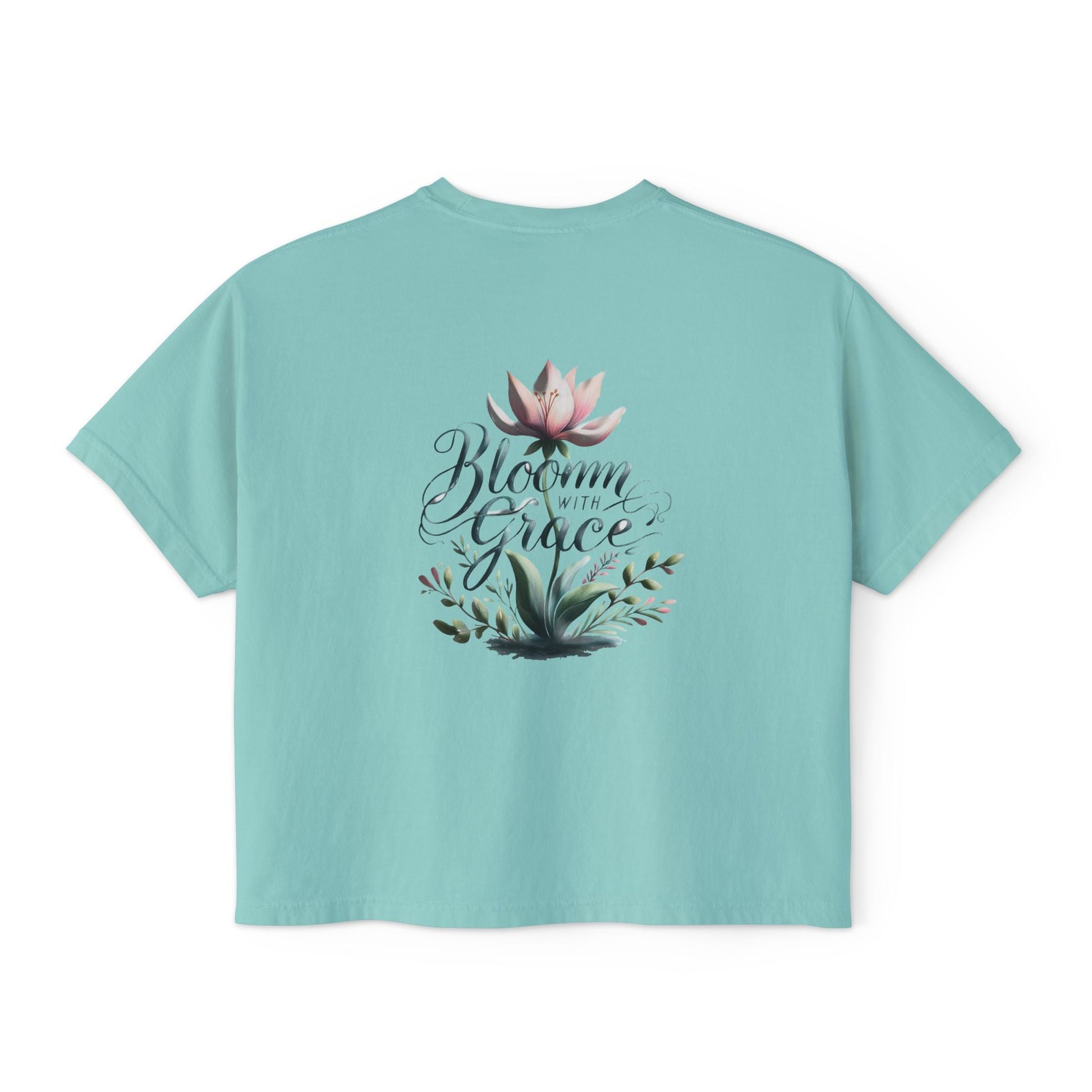 Womens boxy T-shirt with floral design and "Bloom with Grace" slogan.