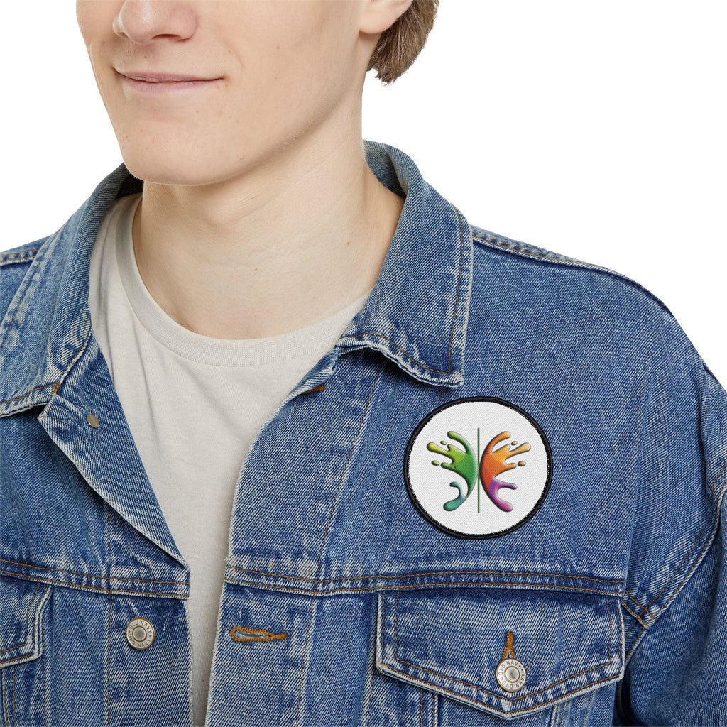 Person wearing a denim jacket with a round, colorful Iron Patch for personalizing apparel.