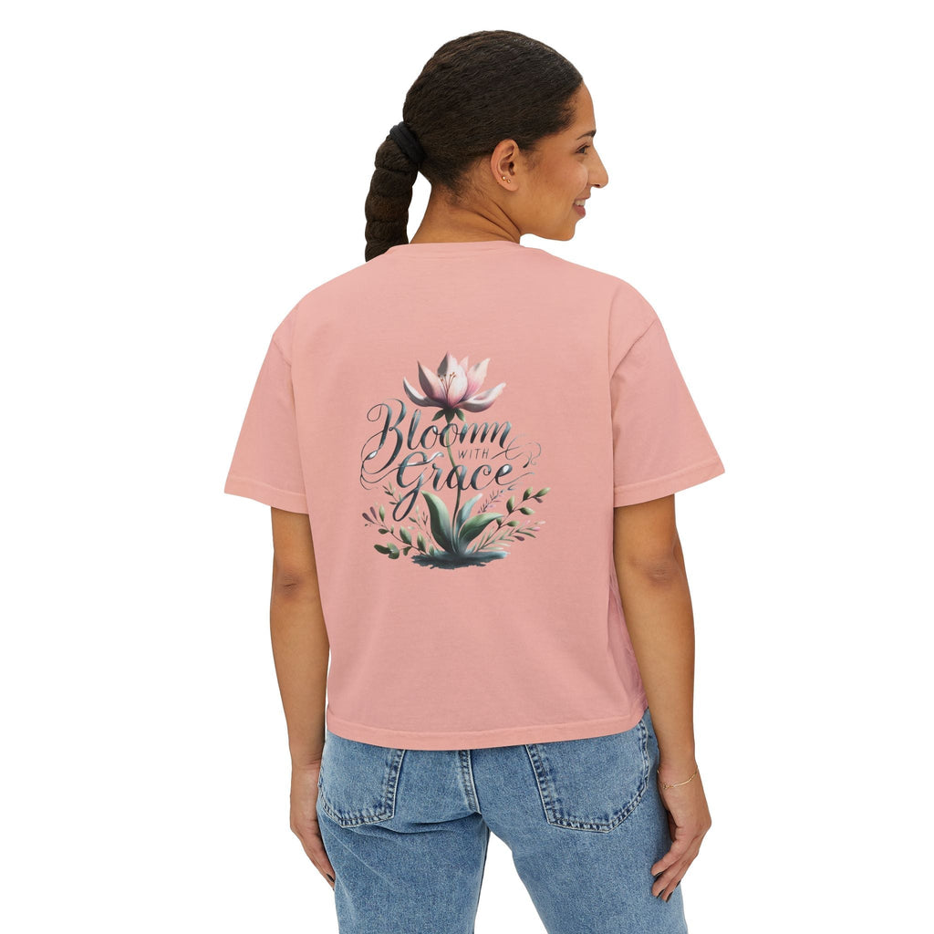 Womens pink boxy T-shirt with floral design and "Bloom with Grace" text, casual summer top.