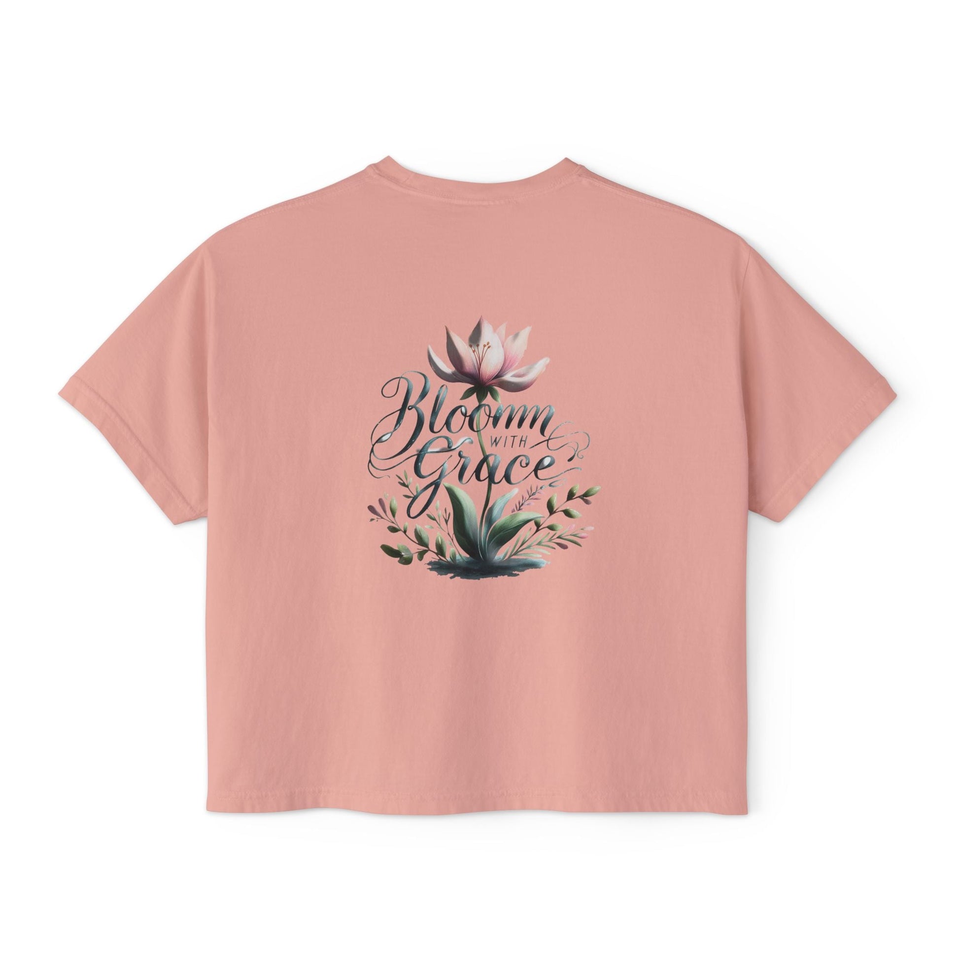 Womens boxy T-shirt in vintage-inspired pink with "Bloom with Grace" floral graphic design.