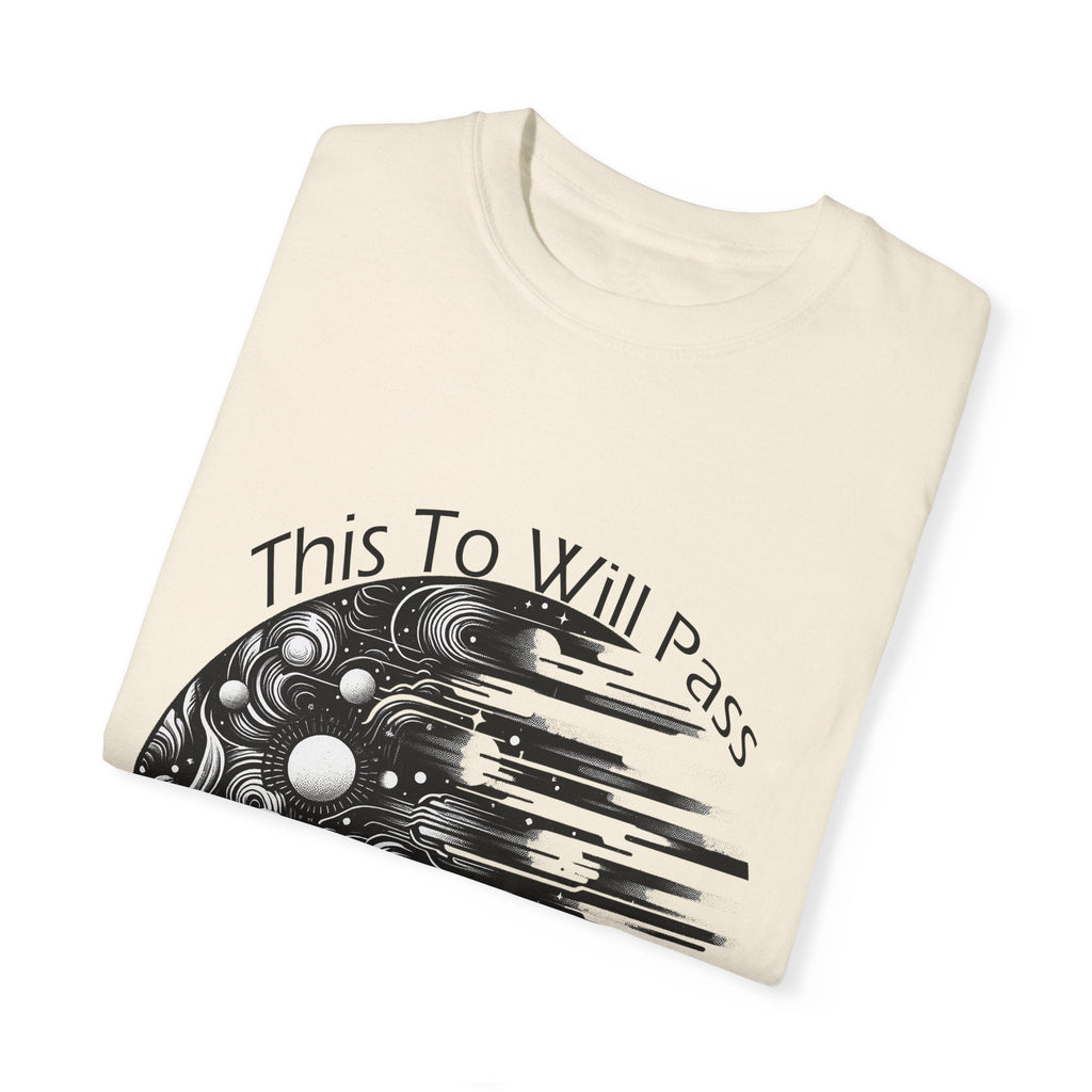 Unisex Garment-Dyed T-Shirt with "This Too Will Pass" inspirational print folded on white background.