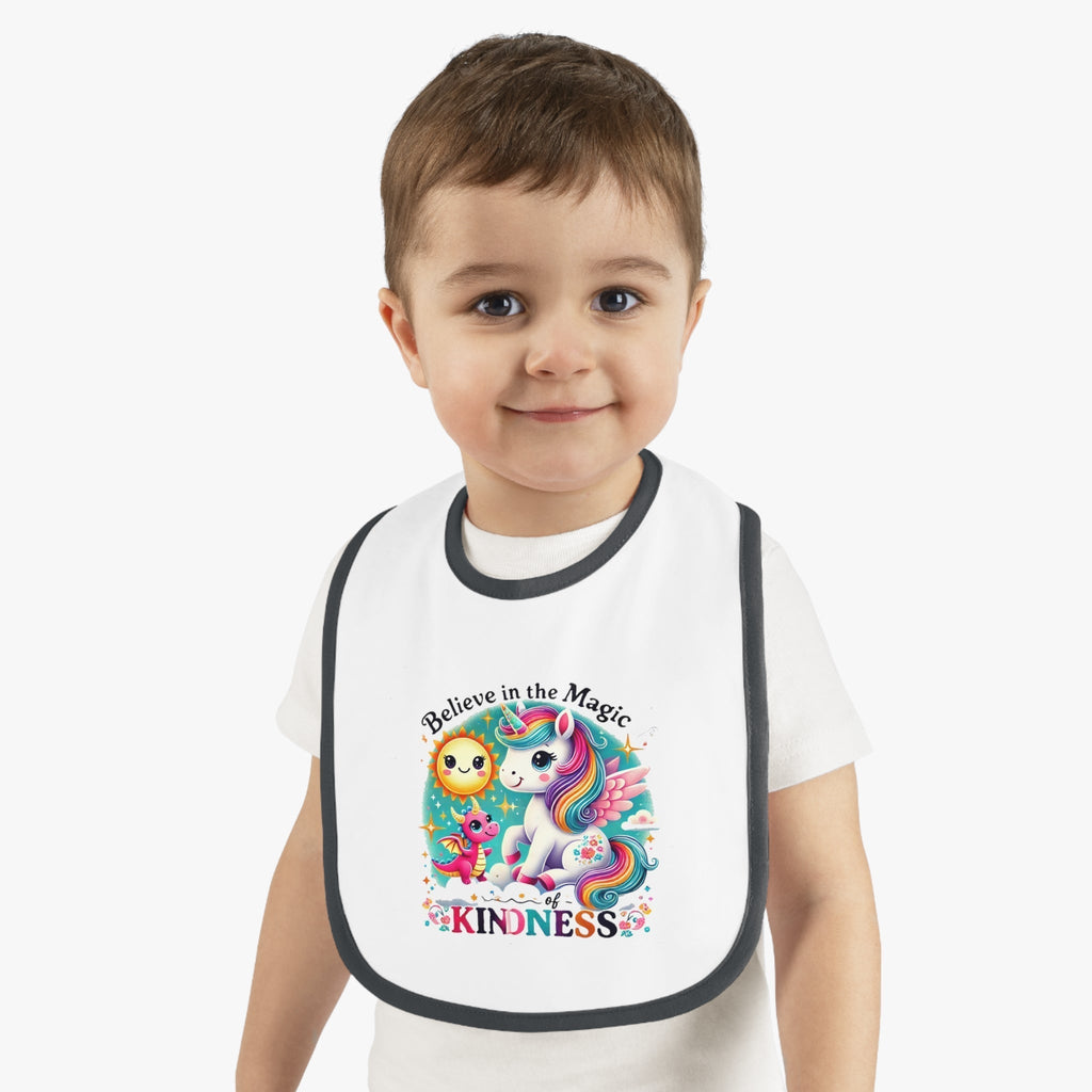 Baby Contrast Trim Jersey Bib with "Believe in the Magic Of Kindness" design on toddler.