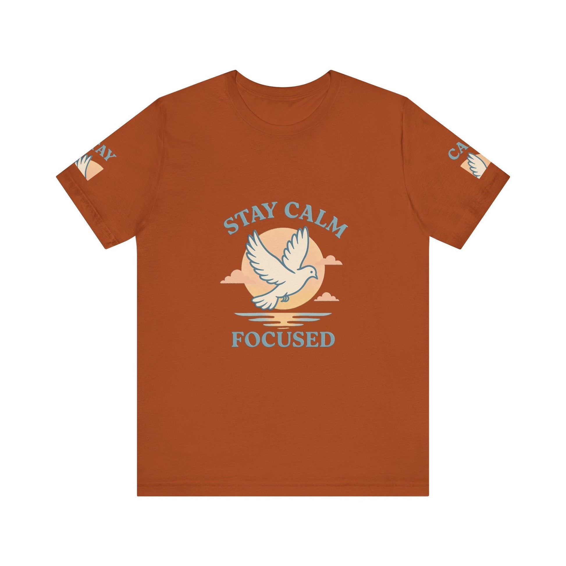 Rust-colored unisex T-shirt with "Stay Calm Focused" text and dove graphic, made of soft breathable cotton, casual inspirational shirt.