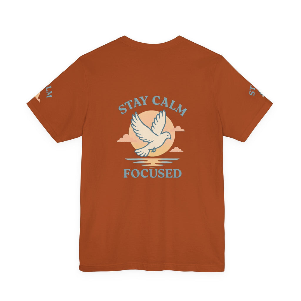 Unisex rust-colored T-shirt with "Stay Calm Focused" text and dove graphic, soft breathable cotton, motivational casual wear