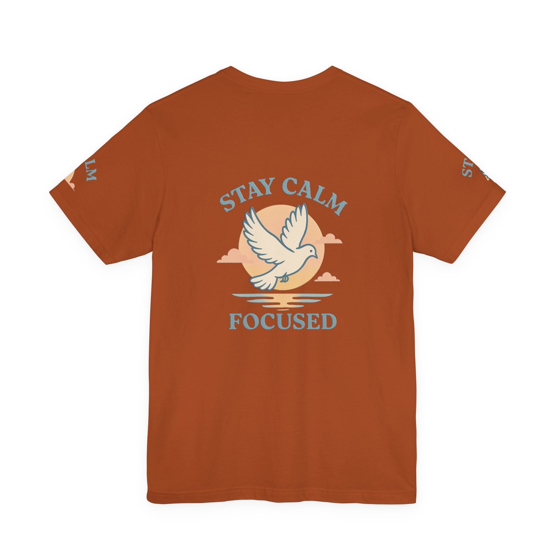 Unisex rust-colored T-shirt with "Stay Calm Focused" text and dove graphic, soft breathable cotton, motivational casual wear
