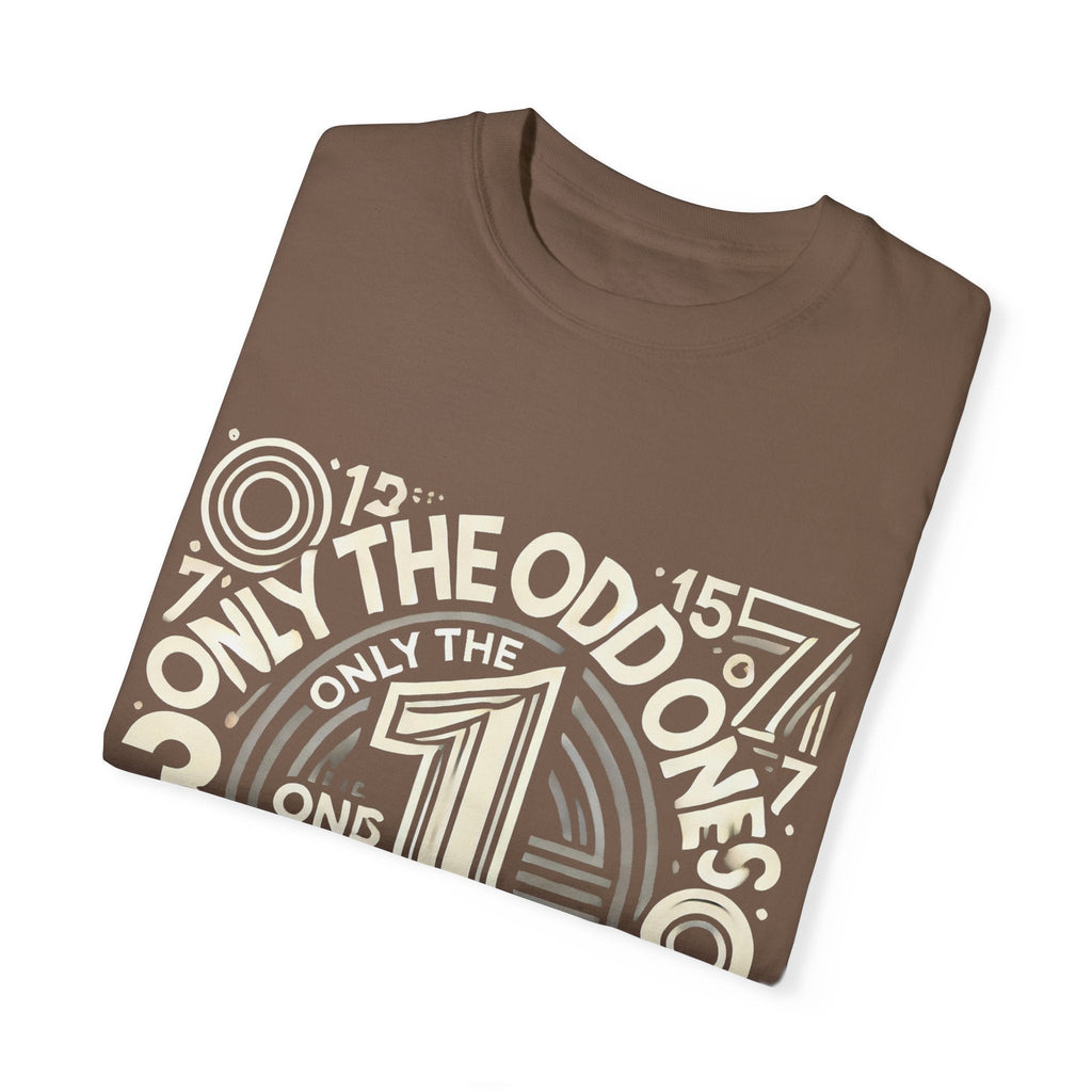 Unisex garment-dyed T-shirt with "Only the Odd Ones Can Be Number One" design, folded neatly.