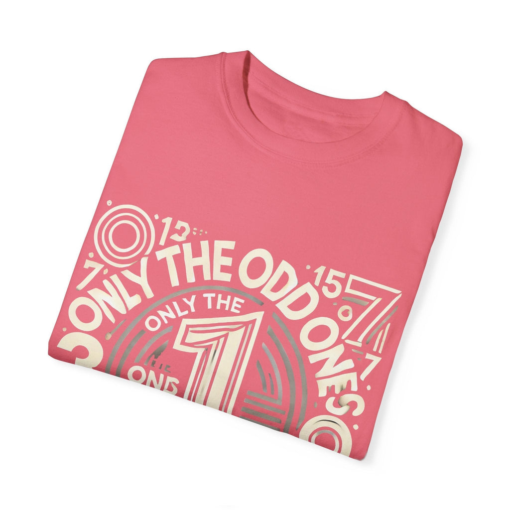 Unisex garment-dyed T-shirt with "Only the Odd Ones Can Be Number One" design, folded, pink color.